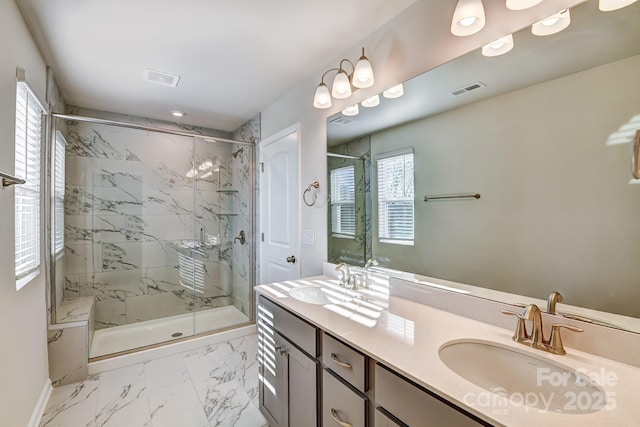 bathroom featuring marble finish floor, a marble finish shower, and a sink