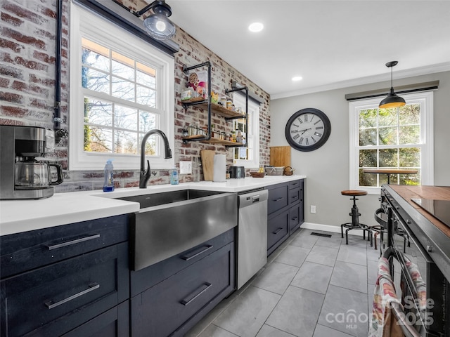 kitchen with visible vents, a sink, stainless steel dishwasher, light tile patterned flooring, and light countertops