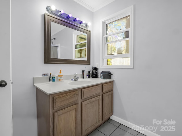 bathroom featuring tile patterned flooring, vanity, crown molding, and baseboards