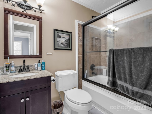 full bath with toilet, vanity, and shower / bath combination with glass door