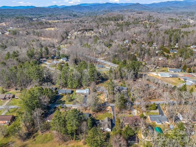 drone / aerial view featuring a forest view and a mountain view