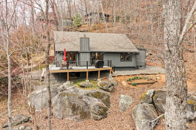 back of property featuring a wooden deck