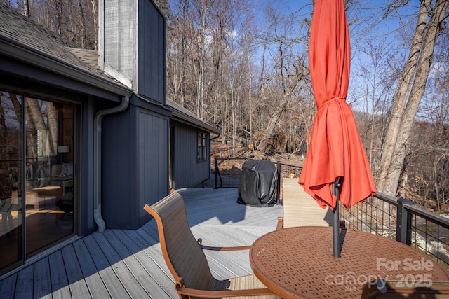 wooden terrace featuring a grill