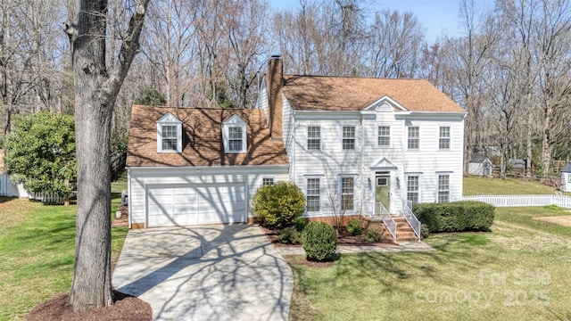 view of front of home featuring a front lawn, fence, concrete driveway, a chimney, and a garage