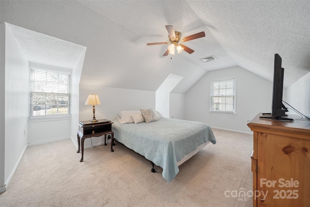 bedroom featuring baseboards, visible vents, lofted ceiling, a textured ceiling, and light colored carpet