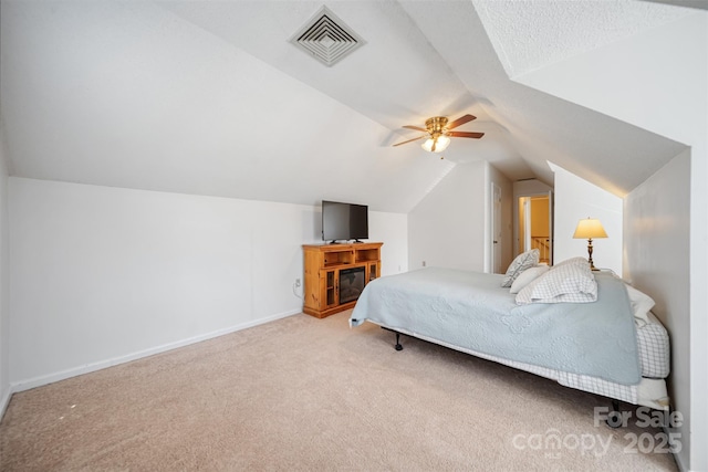 carpeted bedroom with visible vents, ceiling fan, baseboards, and vaulted ceiling