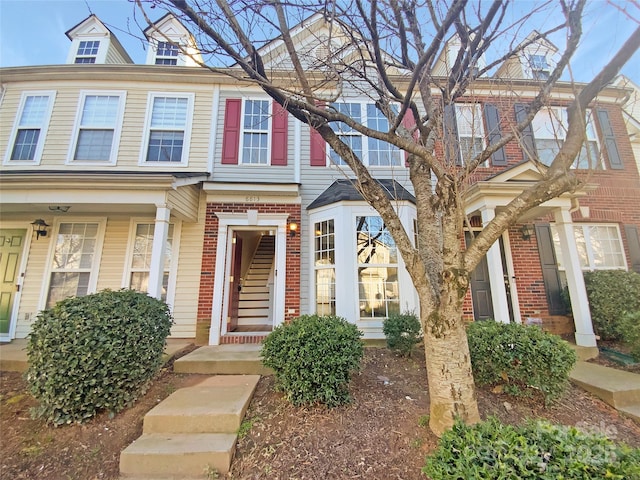 townhome / multi-family property with brick siding