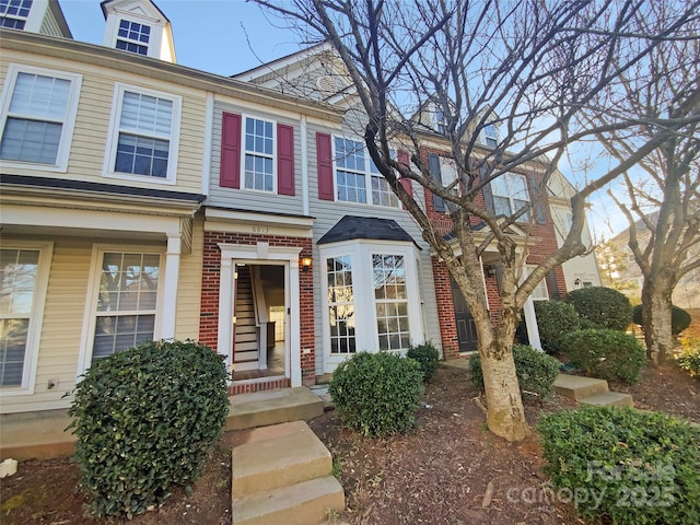 townhome / multi-family property featuring brick siding