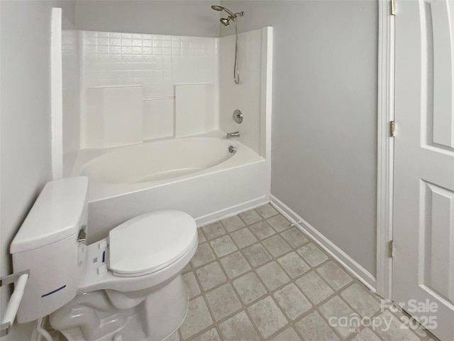 bathroom featuring shower / washtub combination, toilet, and baseboards