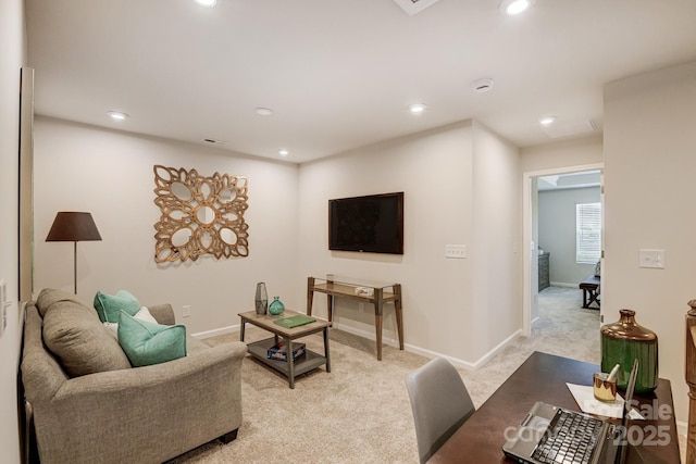 living room with recessed lighting, baseboards, and light carpet