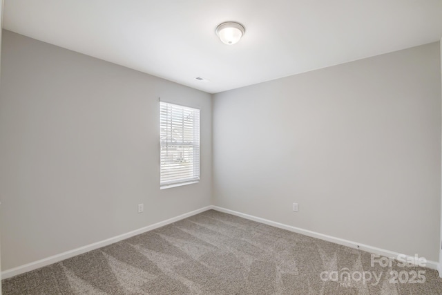 carpeted empty room with baseboards