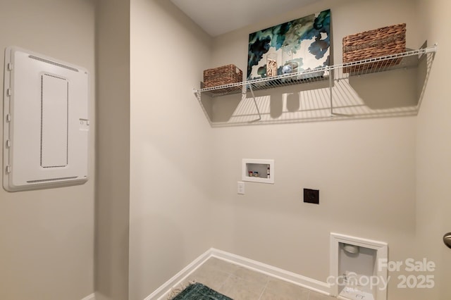 laundry area with laundry area, hookup for a washing machine, hookup for an electric dryer, and baseboards