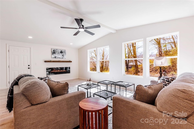 living room featuring lofted ceiling with beams, recessed lighting, ceiling fan, light wood-style floors, and a glass covered fireplace