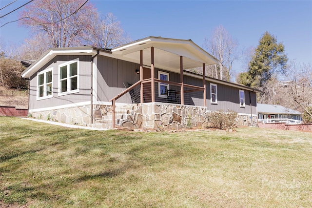 back of property featuring crawl space and a lawn