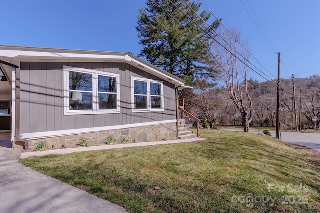 view of home's exterior with crawl space and a yard