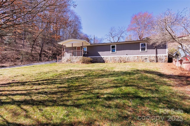 rear view of property with a porch and a lawn