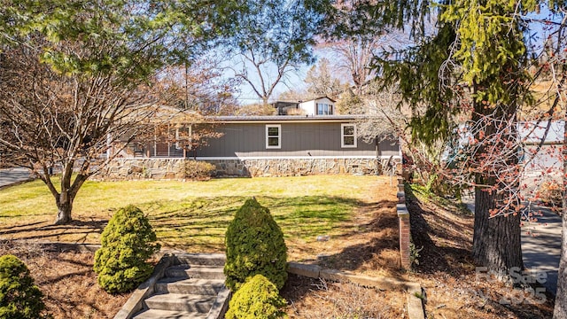 rear view of house featuring a yard