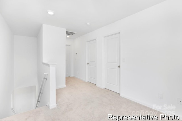 carpeted empty room with visible vents, recessed lighting, and baseboards