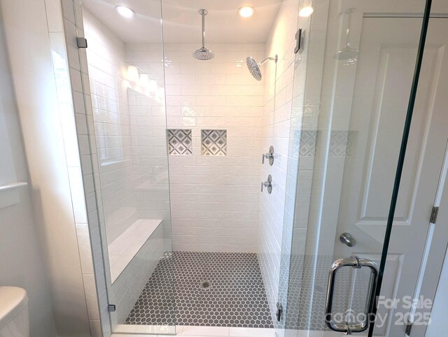 full bathroom with recessed lighting, a stall shower, and toilet