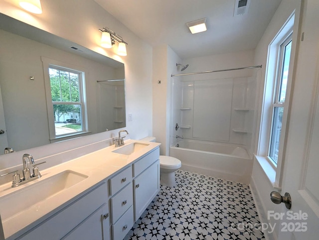 bathroom featuring toilet, tile patterned floors, visible vents, and a sink