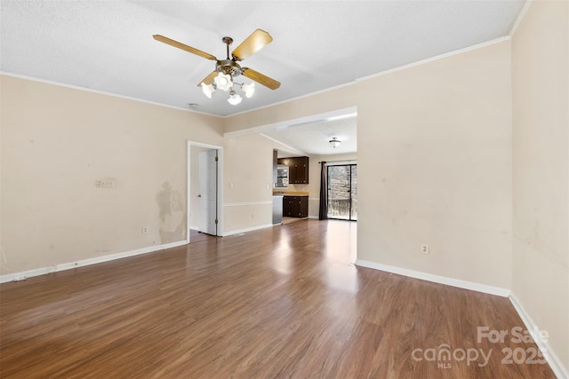 unfurnished living room featuring baseboards, dark wood-type flooring, and ceiling fan