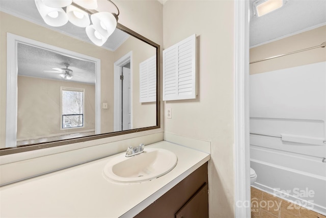 full bath featuring ceiling fan, toilet, vanity, tile patterned floors, and a textured ceiling