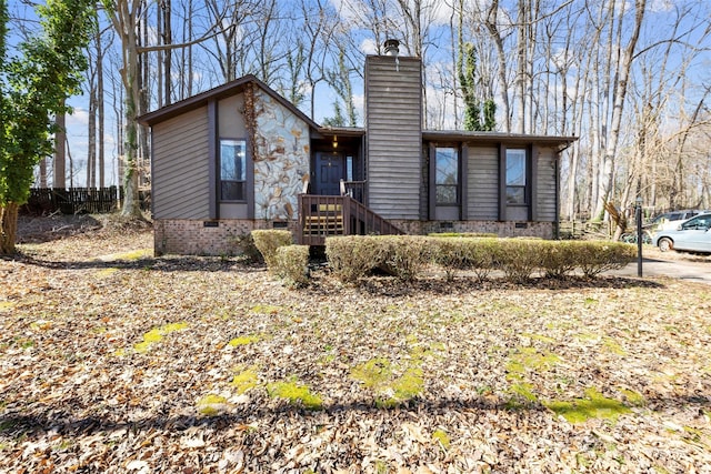 view of front of property with crawl space and a chimney