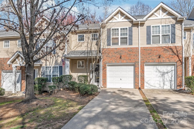 townhome / multi-family property with a garage, brick siding, and concrete driveway