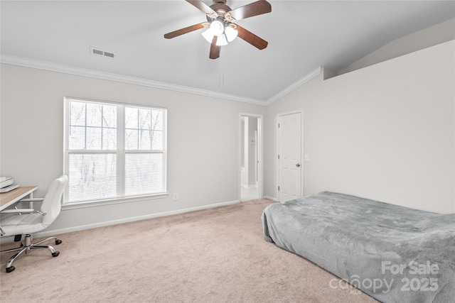 carpeted bedroom featuring lofted ceiling, baseboards, visible vents, and ornamental molding