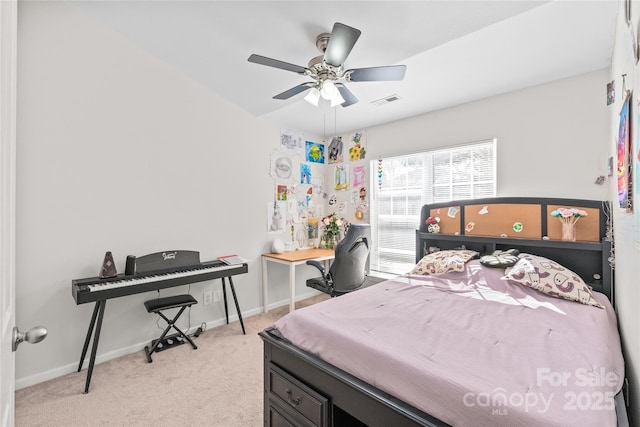 bedroom with light carpet, visible vents, a ceiling fan, and baseboards