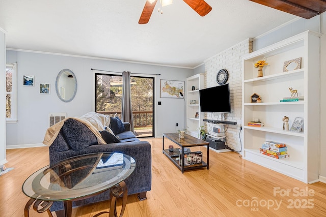 living room featuring ceiling fan, light wood-style floors, baseboards, and ornamental molding