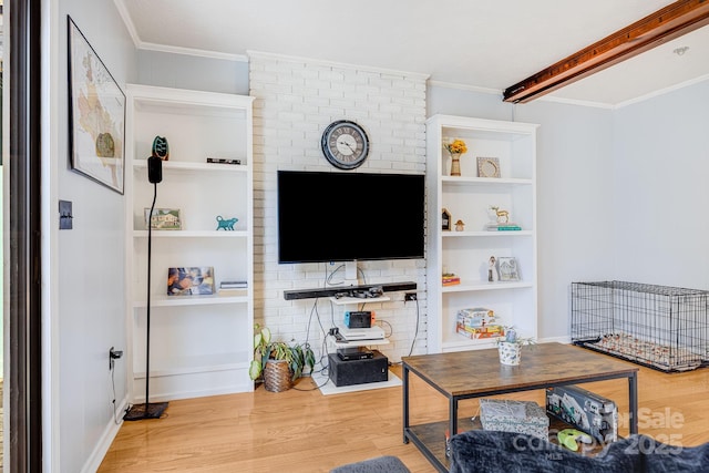 living area featuring wood finished floors, baseboards, and ornamental molding