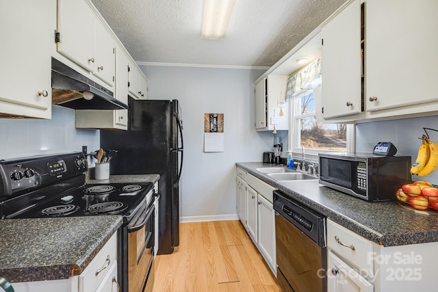 kitchen with stainless steel microwave, under cabinet range hood, black dishwasher, electric stove, and a sink