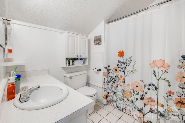 bathroom featuring tile patterned floors, toilet, a textured ceiling, a shower with shower curtain, and vanity