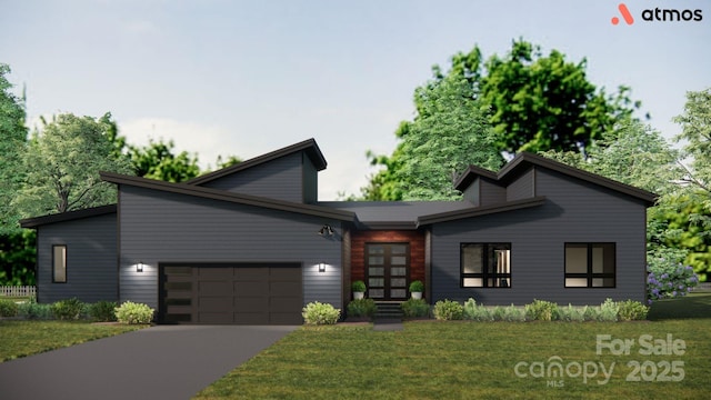 view of front of home with an attached garage, driveway, and a front lawn