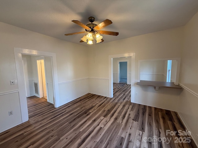 spare room with visible vents, ceiling fan, and wood finished floors