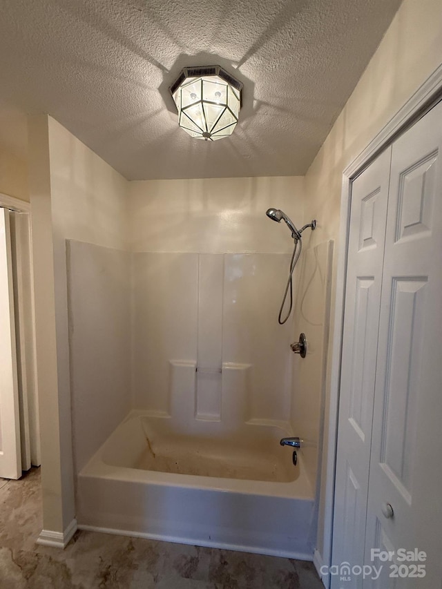 full bath with tub / shower combination and a textured ceiling