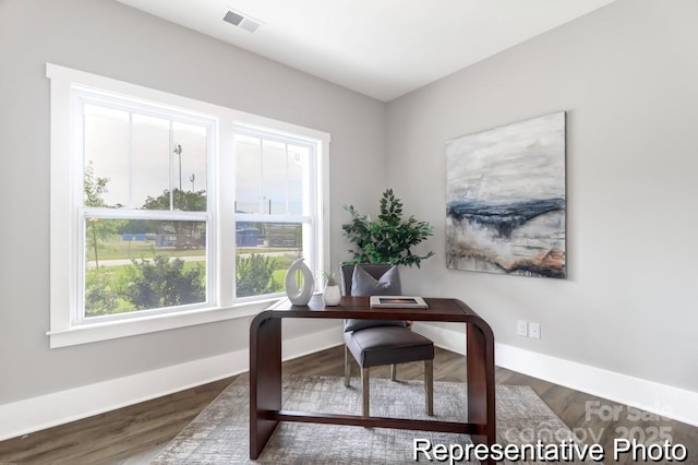 home office with visible vents, baseboards, and wood finished floors