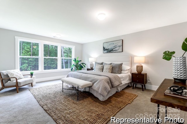 bedroom with carpet flooring and baseboards