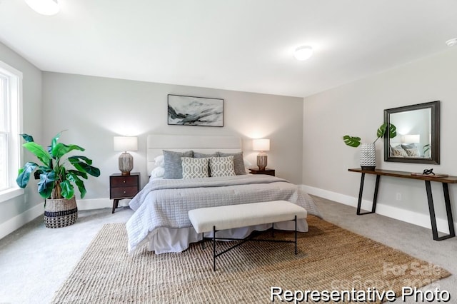 bedroom featuring carpet flooring and baseboards