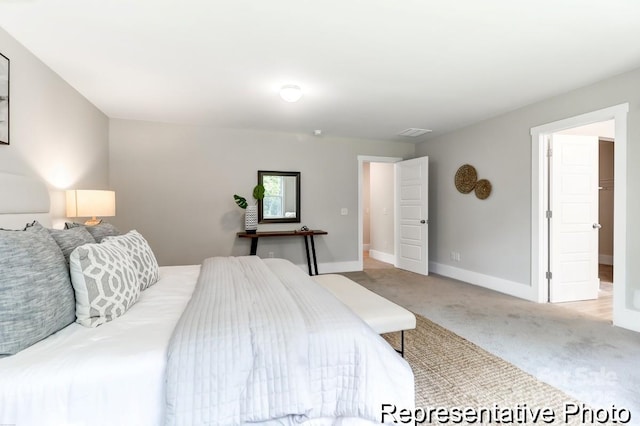 carpeted bedroom featuring visible vents and baseboards