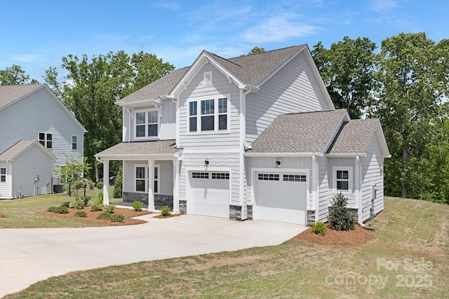 craftsman-style house featuring driveway, an attached garage, stone siding, roof with shingles, and a front lawn