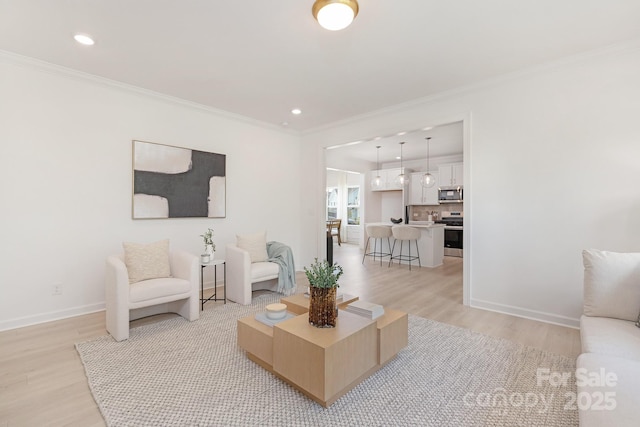 living area with baseboards, recessed lighting, crown molding, and light wood-type flooring