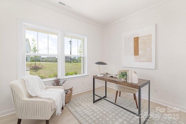 home office featuring crown molding, light wood finished floors, baseboards, and visible vents