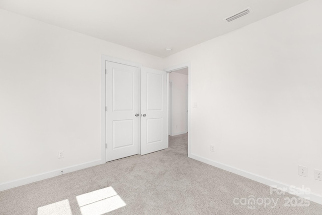 interior space with baseboards, visible vents, and carpet floors