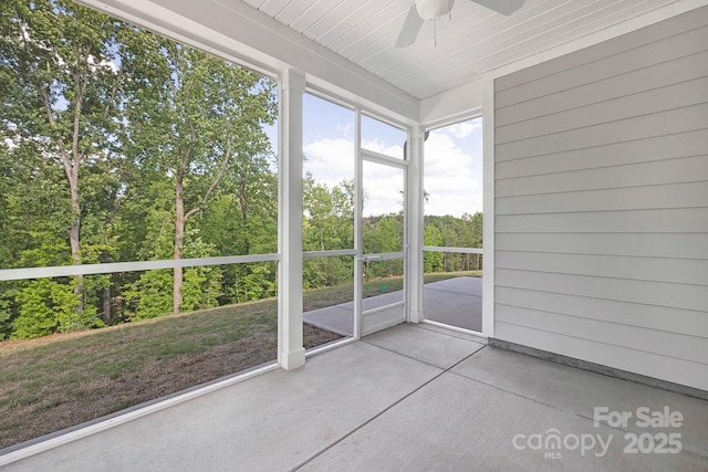 unfurnished sunroom featuring ceiling fan