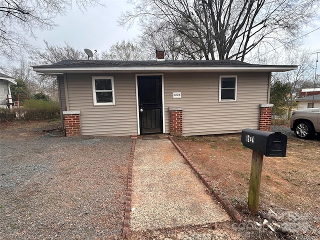 view of front of house featuring a chimney