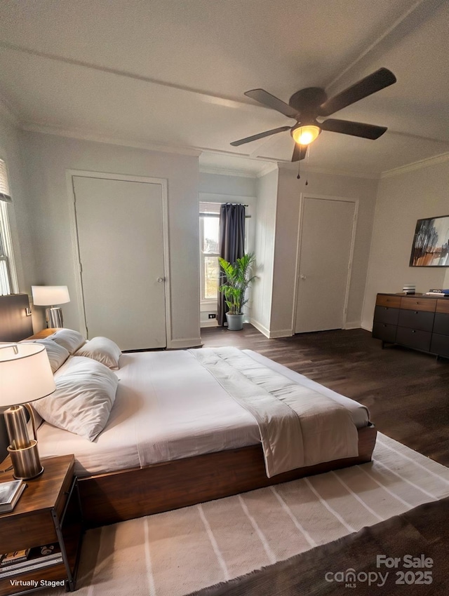 bedroom featuring baseboards, crown molding, a ceiling fan, and wood finished floors