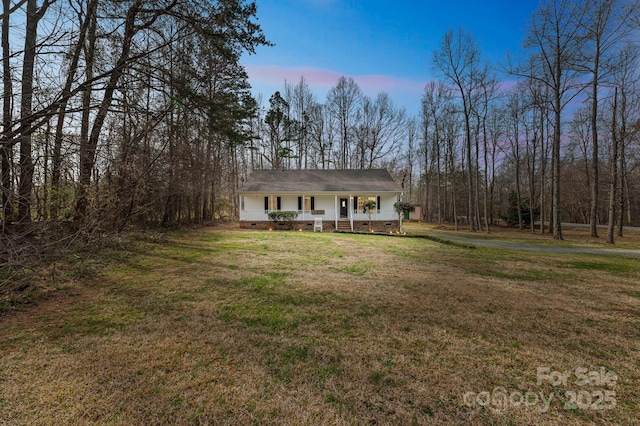 view of front facade featuring a porch, a front lawn, and crawl space