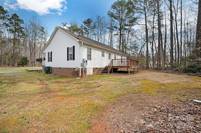 view of property exterior with a wooden deck, a yard, and crawl space